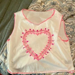 It’s a white crop top, and it sleeveless with a heart design
